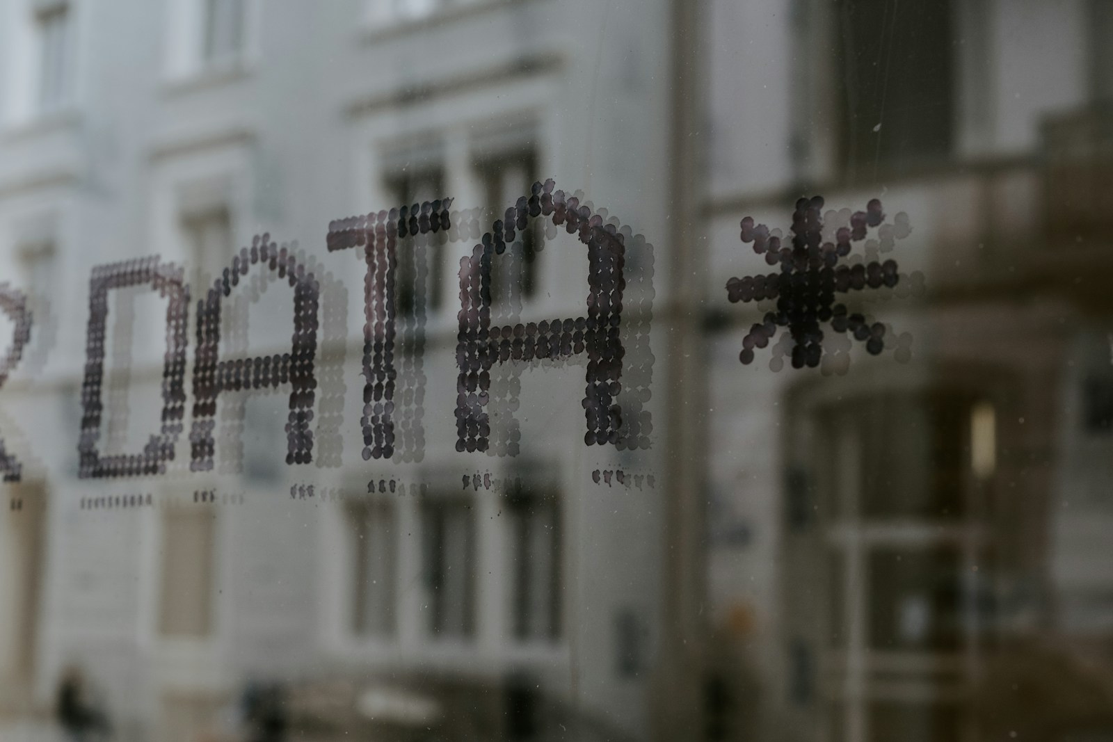 a close up of a window with a building in the background - personal data protection
