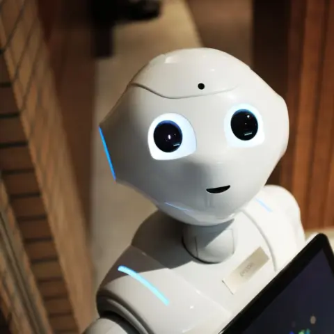 UAE Launches ‘Artificial Intelligence and Data - A futuristic humanoid robot in an indoor Tokyo setting, showcasing modern te
